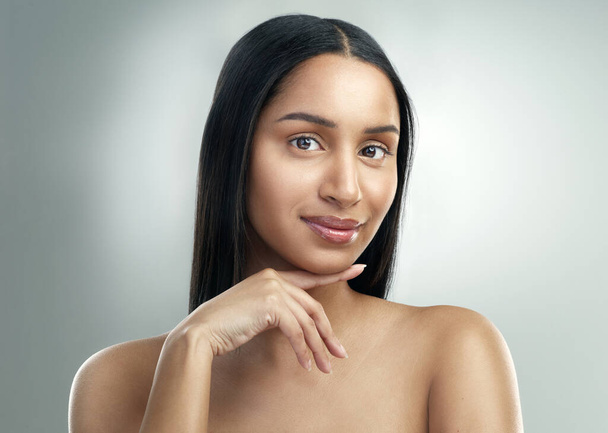 If youre looking for perfect skin, look no further. a beautiful young woman with flawless skin posing against a grey background - Photo, image