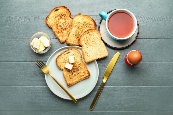 Tasty breakfast with toasts on dark wooden background - Foto, Imagen