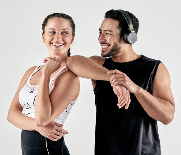 Gotta love the feeling of getting stronger. Studio shot of a sporty young man and woman posing together against a white background - Photo, image