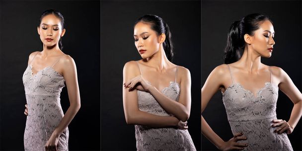 Half body of Asian beautiful woman wear white evening sequin gown, fashion vintage poses. Young female stand express feeling happy smile strong over black background isolated - 写真・画像