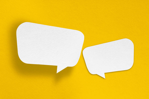 speech balloon shape white paper isolated on yellow background Communication bubbles. - Foto, immagini