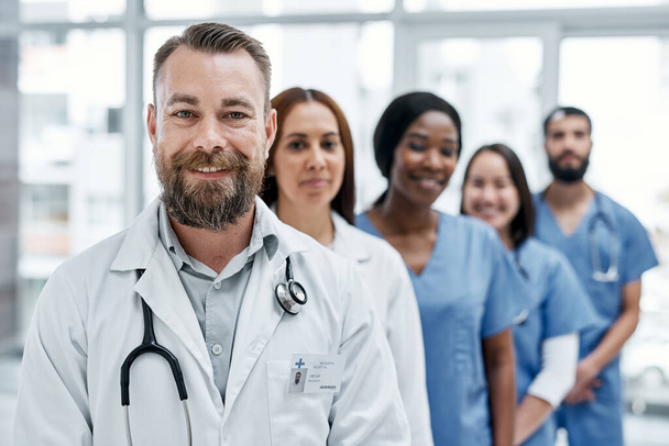 Lets get you moving from good to great health. Portrait of a group of medical practitioners standing together in a hospital - Foto, Bild