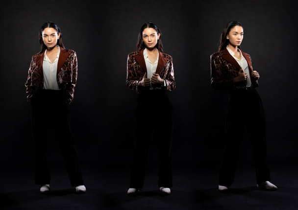 Full length body of Asian beautiful woman wear formal blazer, handsome man look. Young female stand express feeling happy smile strong over black background isolated - Foto, afbeelding