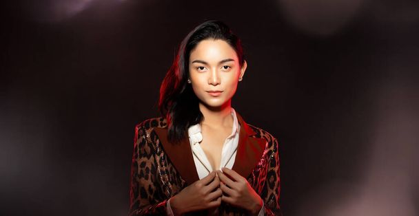 Half body portrait of Asian beautiful woman wear formal blazer, unisex handsome man look make up style. Young female express feeling smile strong over black background isolated copy space - Fotoğraf, Görsel