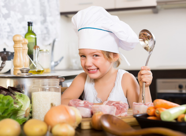 Happy baby girl in cook hat   - Fotó, kép