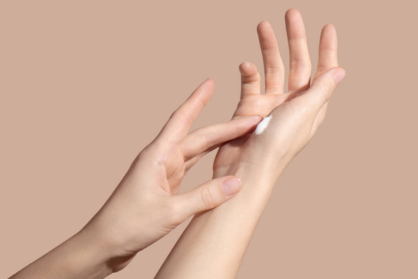Hands of a young woman applying the cream. Skincare concept. High quality photo - Foto, Imagen