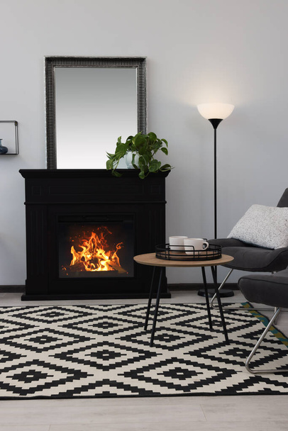 Stylish living room interior with decorative fireplace - Фото, зображення
