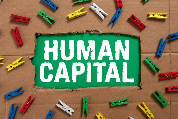 Sign displaying Human Capital, Conceptual photo Intangible Collective Resources Competence Capital Education Important Ideas Written Under Ripped Cardboard With Colored Pegs Around. - Zdjęcie, obraz