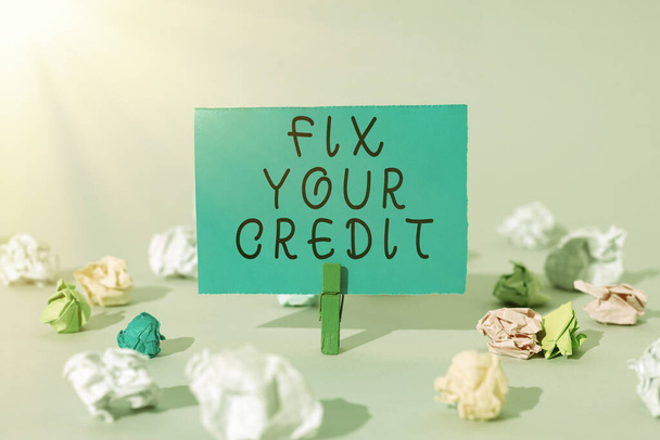 Text caption presenting Fix Your Credit, Concept meaning Keep balances low on credit cards and other credit Important Message Presented On Piece Of Paper Clipped With Clip. - Foto, afbeelding