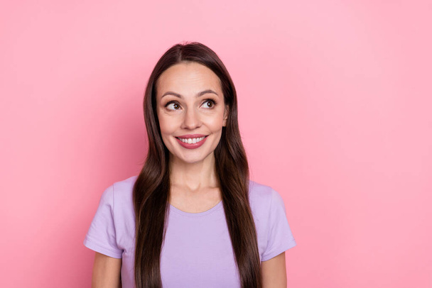 Portrait of positive pretty girl look interested empty space toothy smile isolated on pink color background. - Fotografie, Obrázek