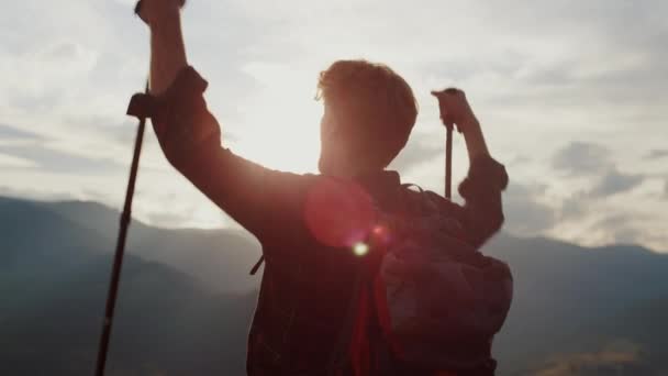Closeup euphoric hiker celebrate win raise hands in mountains nature. Emotional traveler reach peak on landscape hill. Satisfied ginger guy scream on extreme trip journey. Success freedom concept. - Footage, Video