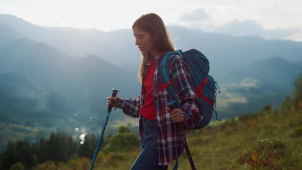 Thoughtful woman explore picturesque nature. Carefree hiking girl walk travel mountain landscape at sunrise close up. Tired traveler going trekking on summer holiday activity. Wanderlust relax concept - Imágenes, Vídeo