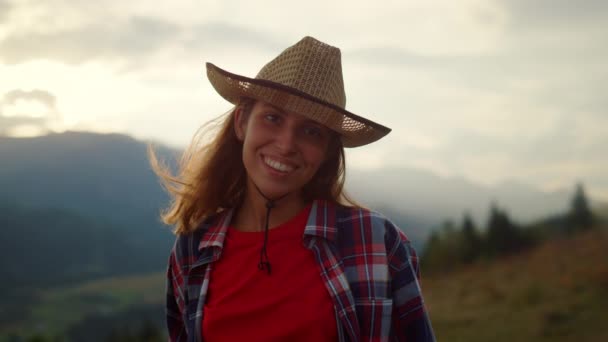 Cheerful woman enjoy nature on mountains hill. Close up happy girl enjoy weekend outside. Smiling beautiful hiker look camera on picturesque landscape. Young model posing on rural view. Travel concept - Filmagem, Vídeo