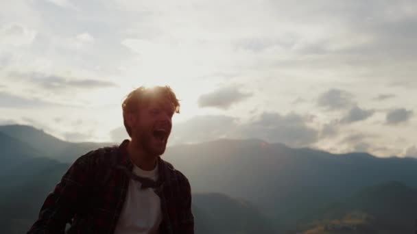 Happy traveler hike mountains. Close up young tourist reach peak on nature sunset. Excited guy celebrate enjoy success on wanderlust adventure. Silhouette joyful backpacker outdoors. Freedom concept - Video