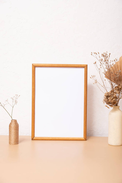Mock up empty wooden frame mockup, dried grass and palm leaves on white background, interior, home design. Art concept. copy space. - Photo, image