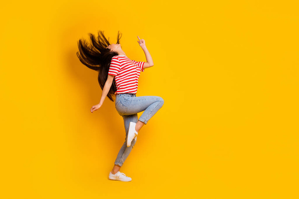 Full size profile portrait of overjoyed satisfied lady flying black hairdo dancing isolated on yellow color background. - Foto, imagen
