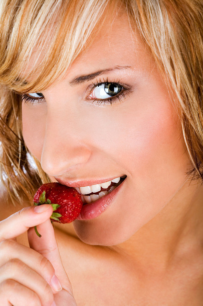 Krásná žena, kousání jahody - Fotografie, Obrázek