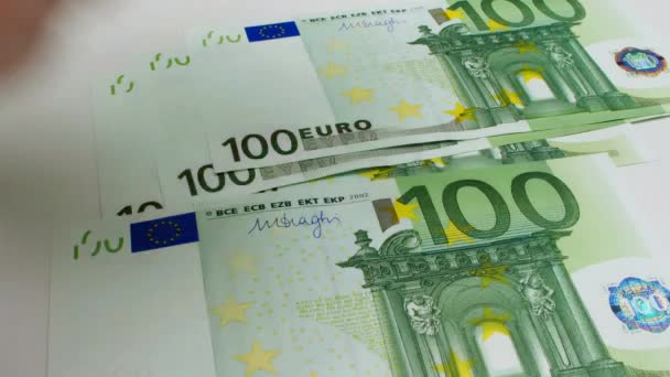 Recalculation of money. Hands count European Euro bills on white background. One hundred Euro banknotes pack. Close-up. EU currency. Money in hand. High quality 4k footage - Séquence, vidéo
