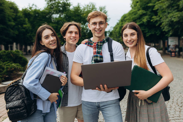 Group of happy smiling students Outside College looking excited in laptop - Foto, Bild