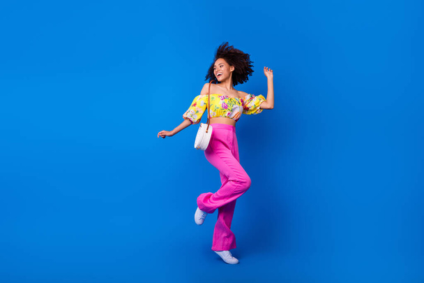 Full length photo of overjoyed pretty girl have fun dancing clubbing isolated on blue color background. - Zdjęcie, obraz