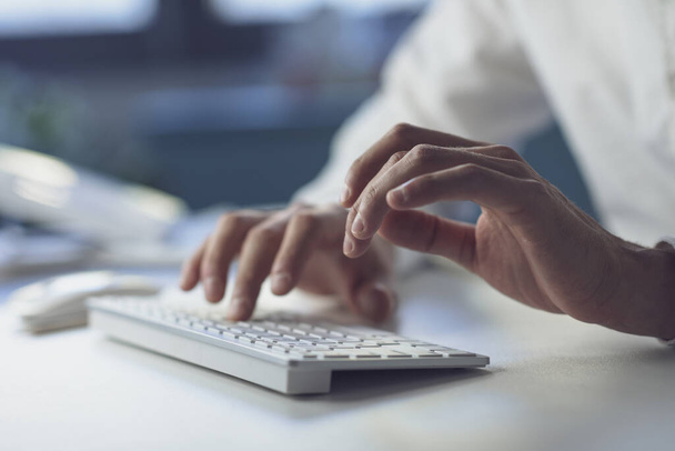Corporate businessman sitting at desk and typing, hands close up - Fotografie, Obrázek