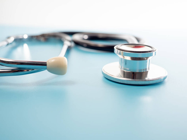 Medical stethoscope. Stethoscope on a blue background close up. - 写真・画像