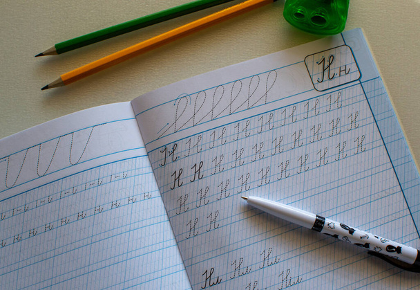 Back to school, learning to write letters correctly, notebook and pencils - Photo, image