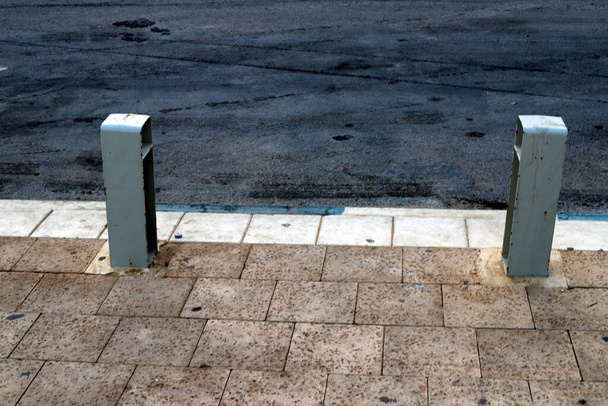 Fencing along the road to separate the carriageway from the sidewalk.  - Φωτογραφία, εικόνα