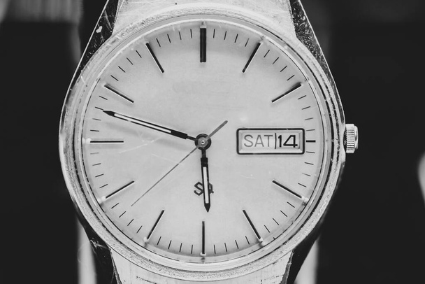 Macro photo of a men's watch. Clock hands. An antique clock. Black and white photo. Time signals. Wristwatch. - Фото, изображение