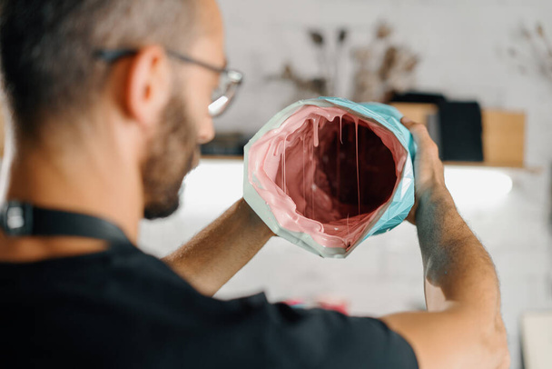 Male artist sculptor artisan creates vase with his own hands in an art workshop. - Zdjęcie, obraz