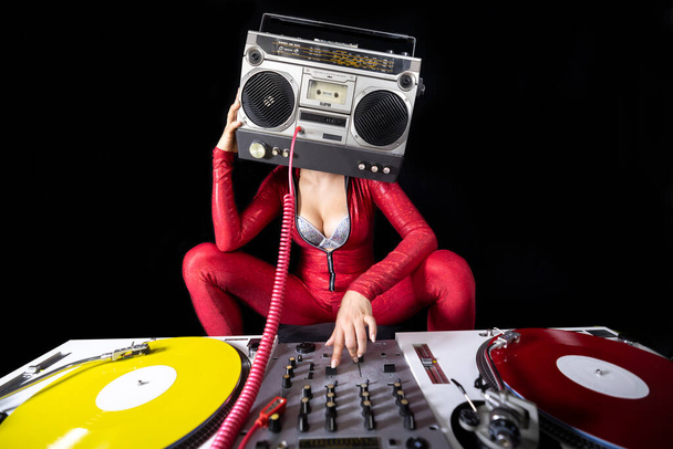 A female dj playing with a ghettoblaster for a head dancing with turntables  - Zdjęcie, obraz