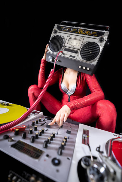 A female dj playing with a ghettoblaster for a head dancing with turntables  - Foto, Imagen