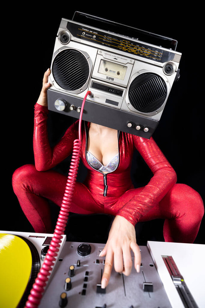 A female dj playing with a ghettoblaster for a head dancing with turntables  - Foto, imagen