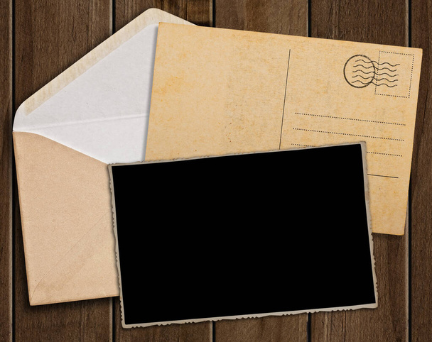 Old postcard, photo and envelope on wooden table. - Φωτογραφία, εικόνα