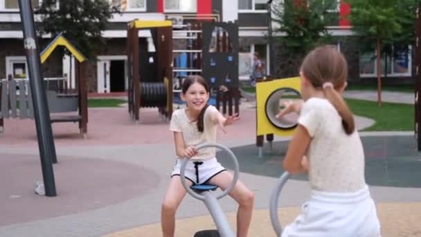 sisterhood, friendship. two charming teen girls having fun on a modern playground. sister, bffs communication.  - Séquence, vidéo