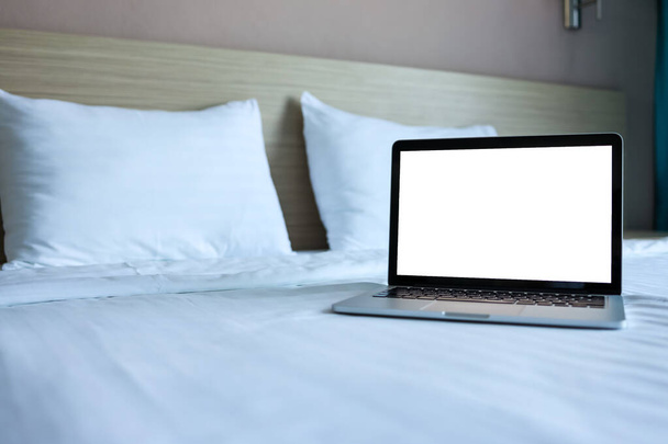 Mock up Blank screen laptop on the bed for advertising and text. - Foto, imagen