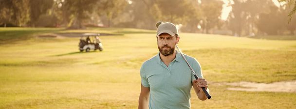 portrait of golfer in cap with golf club. people lifestyle. serious man after game on green grass. summer activity. professional sport outdoor. male golf player on professional golf course. - Photo, Image