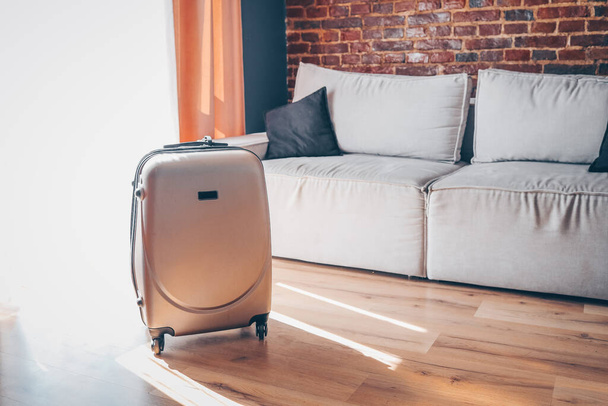 Suitcase in a bright modern apartment - Фото, изображение