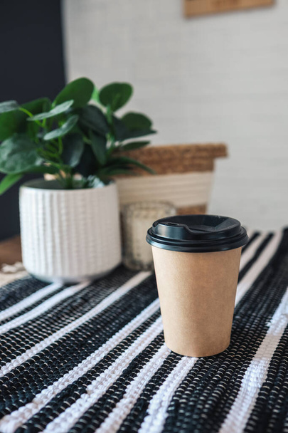 Paper cup of coffee on cafe table in scandinavian style. - Fotoğraf, Görsel