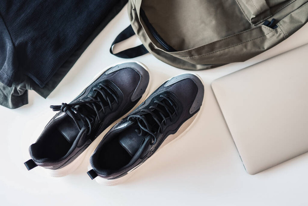 Set of men's things, flat lay top view. Sneakers, backpack, laptop on white background. - Φωτογραφία, εικόνα