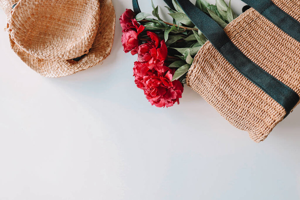 Wicker hat and bag with peonies. Summer photography, space for text - Fotoğraf, Görsel