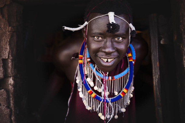 Portrait of Maasai mara man with traditional colorful necklace at Maasai Mara tribe village, Safari travel destination near Maasai Mara National Reserve, Kenya - Photo, image