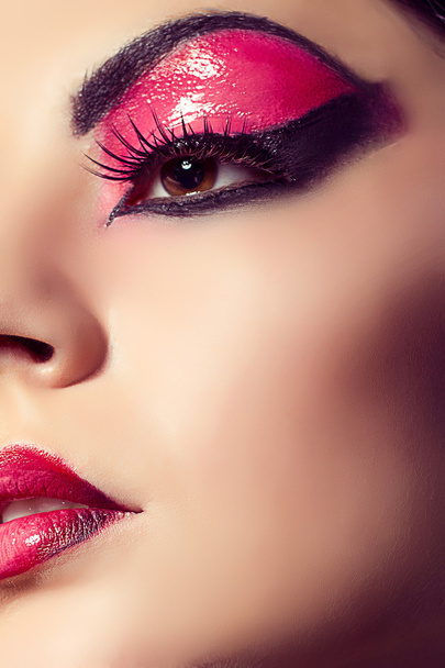 Close up fashion model portrait. Scarlet makeup. Black arrows. - Фото, изображение