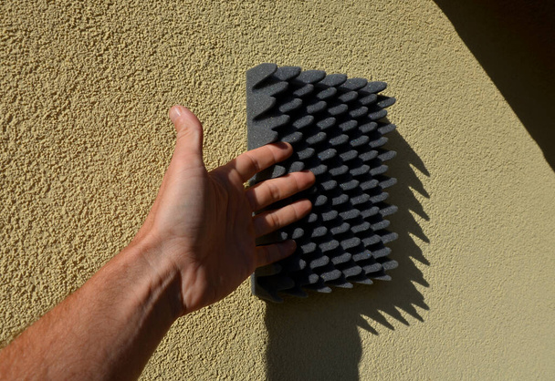 installation of anti-noise foam tiles is demonstrated by the seller. very porous soft material absorbs sounds and protects fruit products from bruises during transport and storage - Photo, Image