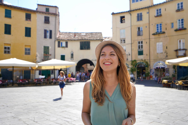 Discovering Italy. Cheerful young woman visiting the historic city of Lucca, Tuscany, Italy. - Fotó, kép