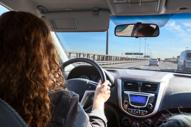 Woman driving vehicle on highway - Fotoğraf, Görsel