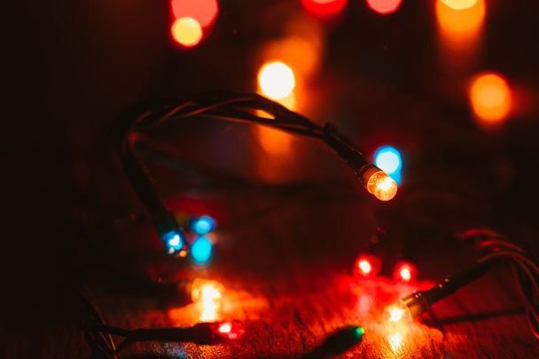 Christmas lights on wooden background. Selective focus - Fotoğraf, Görsel