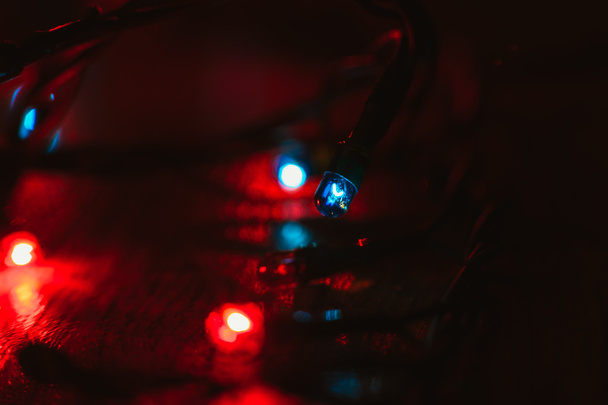 Christmas lights on wooden background. Selective focus - Foto, Imagen
