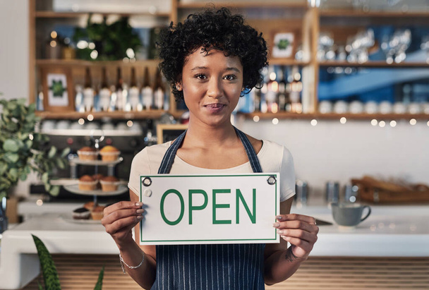 Weve just opened and would appreciate your support. Portrait of a young woman holding an open sign a cafe - Fotoğraf, Görsel