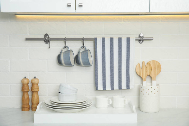 Clean towel, utensils and dishware in kitchen - Foto, immagini